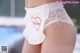 A close up of a woman wearing a white panties with a red heart on it.